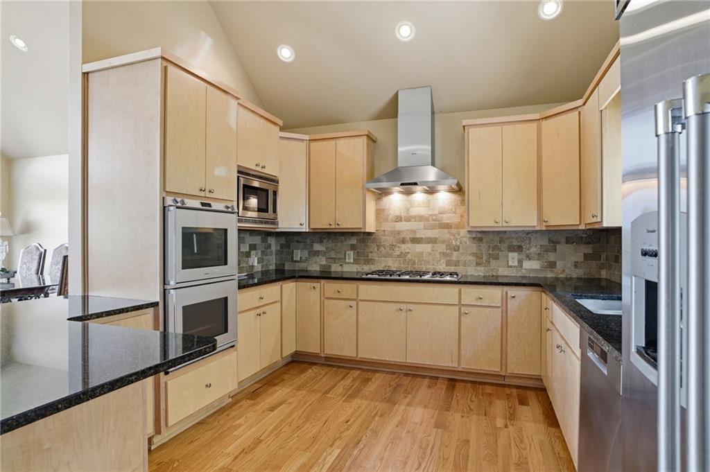 3326 Monument Road Jasper, GA 30143 - Photo 6 of 49 a kitchen with stainless steel appliances a sink cabinets and wooden floor