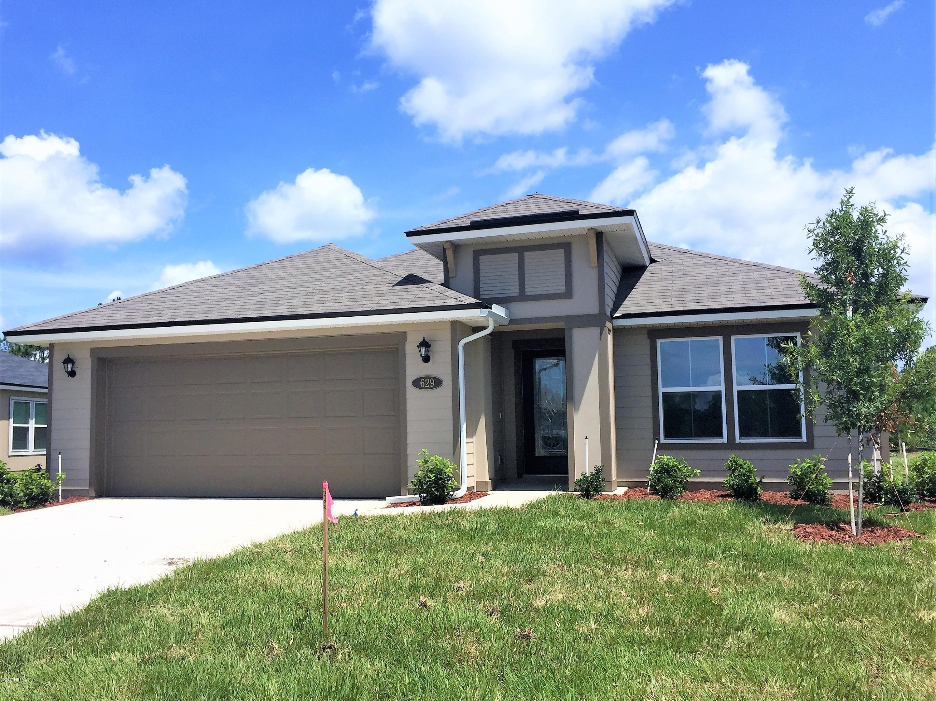 629 Deer Crossing Road St. Augustine, FL 32086 - Photo 1 of 5 a front view of a house with a yard and garage