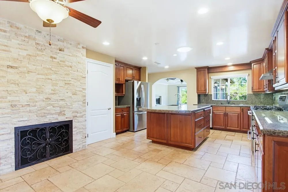12858 Stone Canyon Road Poway, CA 92064 - Photo 10 of 57 Gas log fireplace and also a built-in work station with drawer and countertop.