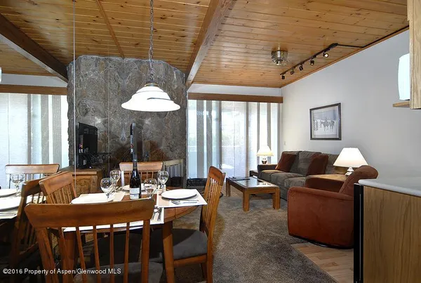 a dining room with furniture and window