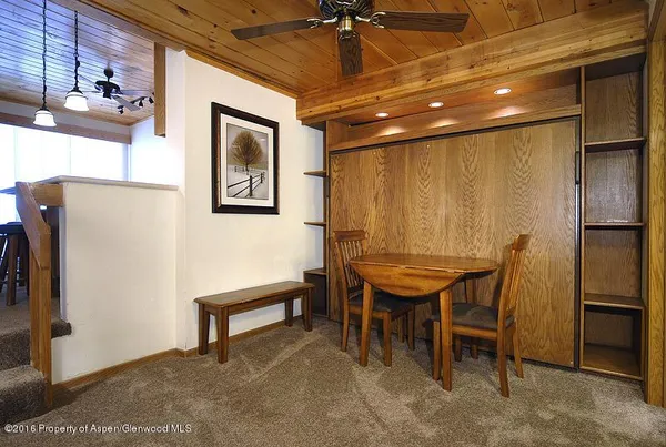 a room with furniture pool table and projector