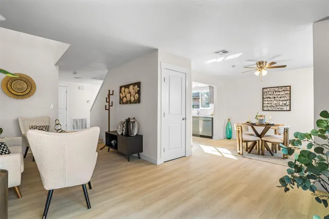 a living room with furniture and wooden floor