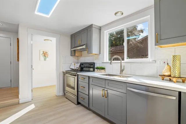 a kitchen with a sink cabinets and window