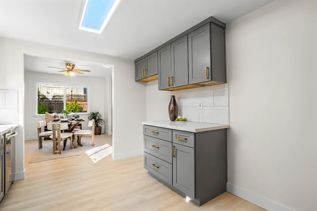 a kitchen with cabinets and wooden floor
