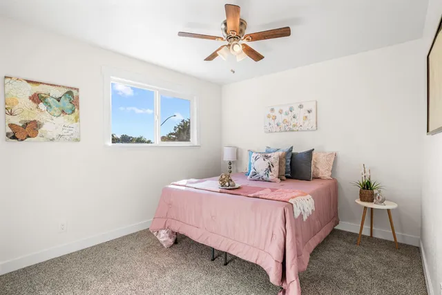 a bathroom with a granite countertop sink a toilet and a bathtub
