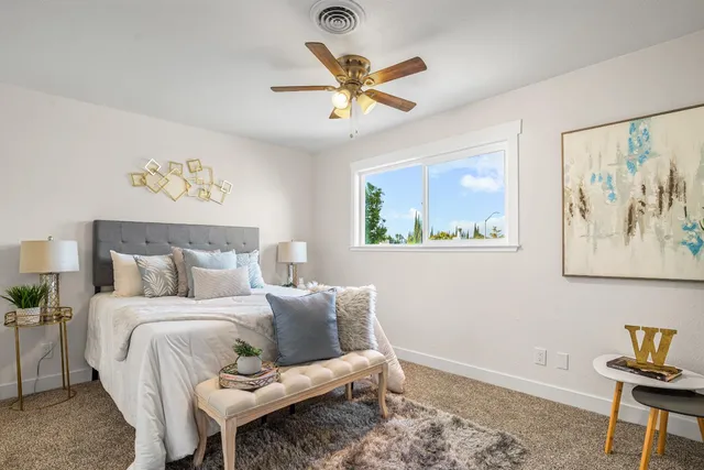 a bed room with a bed and a chandelier