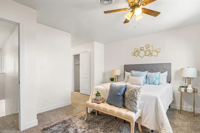 a bedroom with a bed and a chandelier