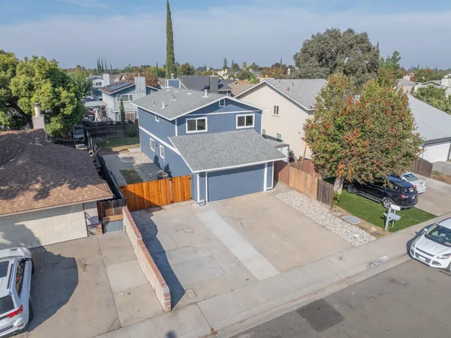 an aerial view of a house with a backyard