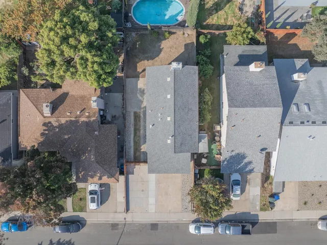 an aerial view of a house with swimming pool and outdoor seating