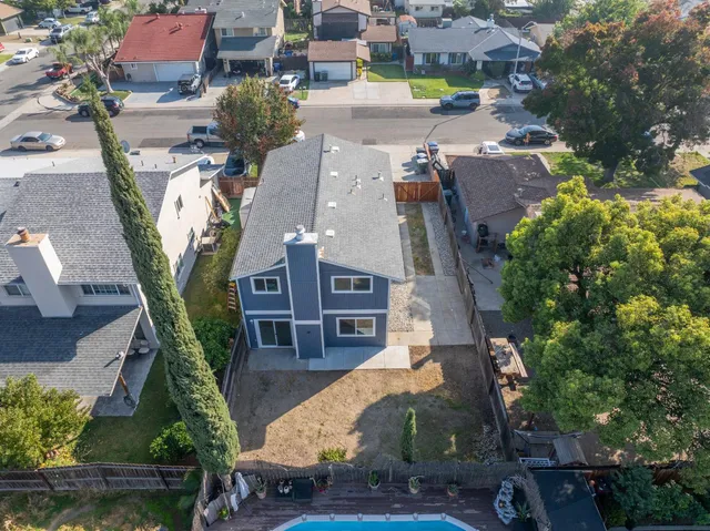 an aerial view of a house with a yard