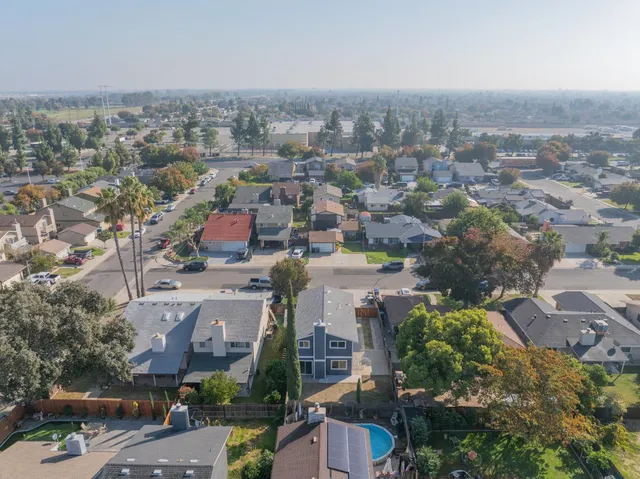 an aerial view of residential houses with city view