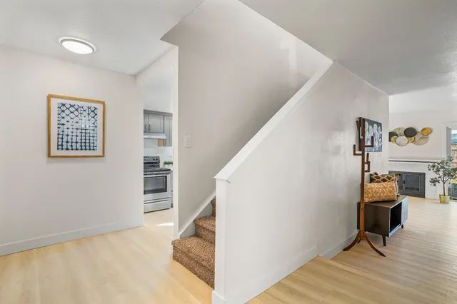 a view of a livingroom with workspace and a window