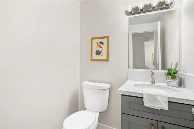 a bathroom with a toilet a sink and mirror