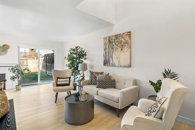 a living room with furniture and a potted plant