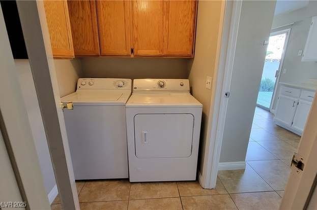 1016 Vantage Point Road Las Vegas, NV 89128 - Photo 16 of 18 Laundry room with light tile patterned floors, baseboards, and washing machine and dryer