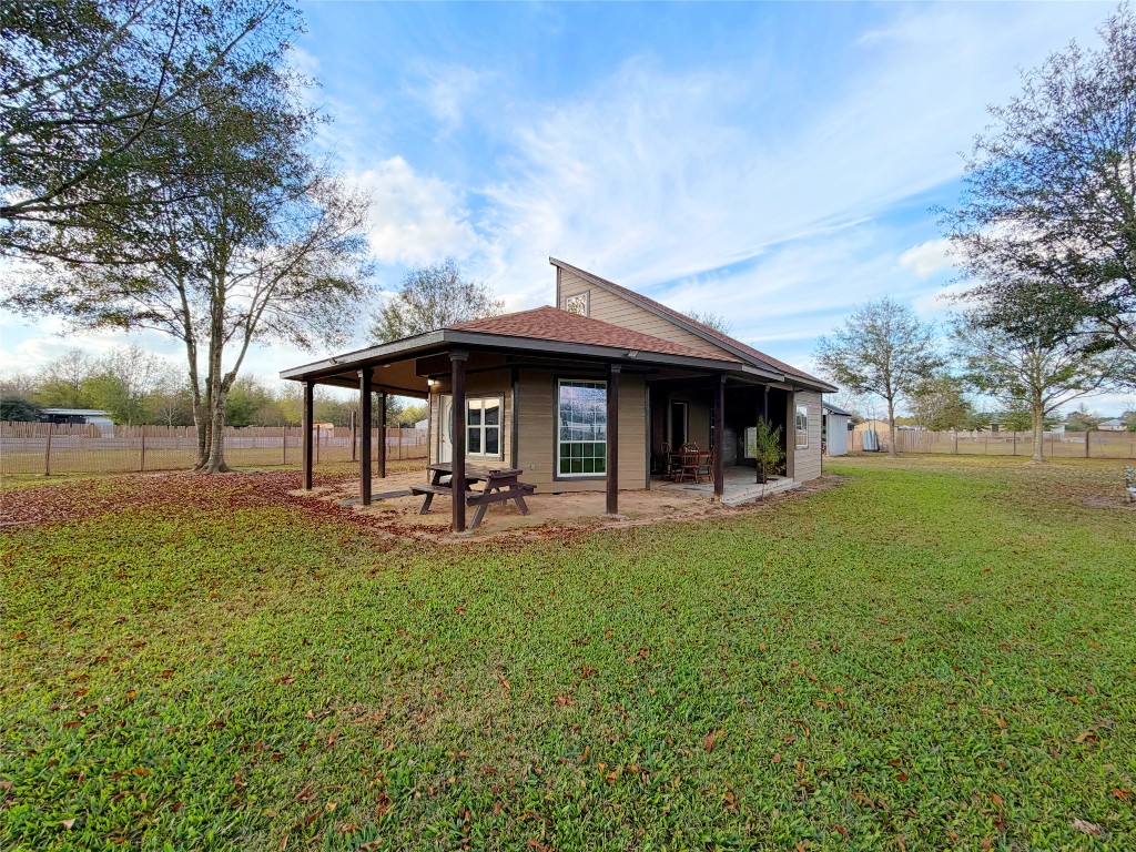 a view of a house with backyard porch and garden