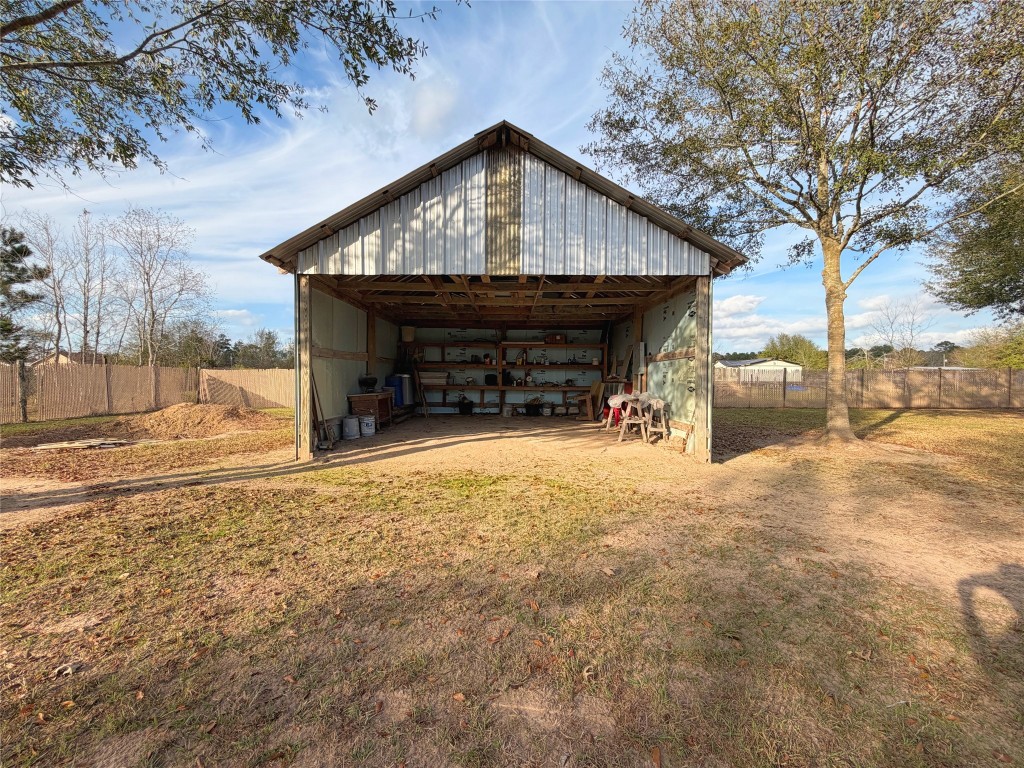 369 Road 3556 Cleveland, TX 77327 - Photo 15 of 16 a front view of a house with a yard and garage