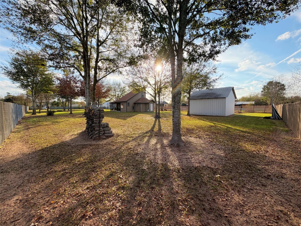 369 Road 3556 Cleveland, TX 77327 - Photo 16 of 16 a view of a yard with a tree