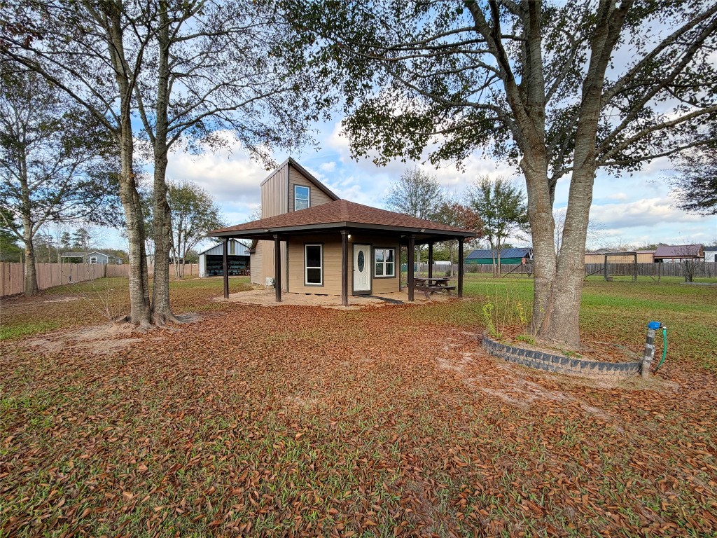 369 Road 3556 Cleveland, TX 77327 - Photo 4 of 16 a backyard of a house with lots of green space