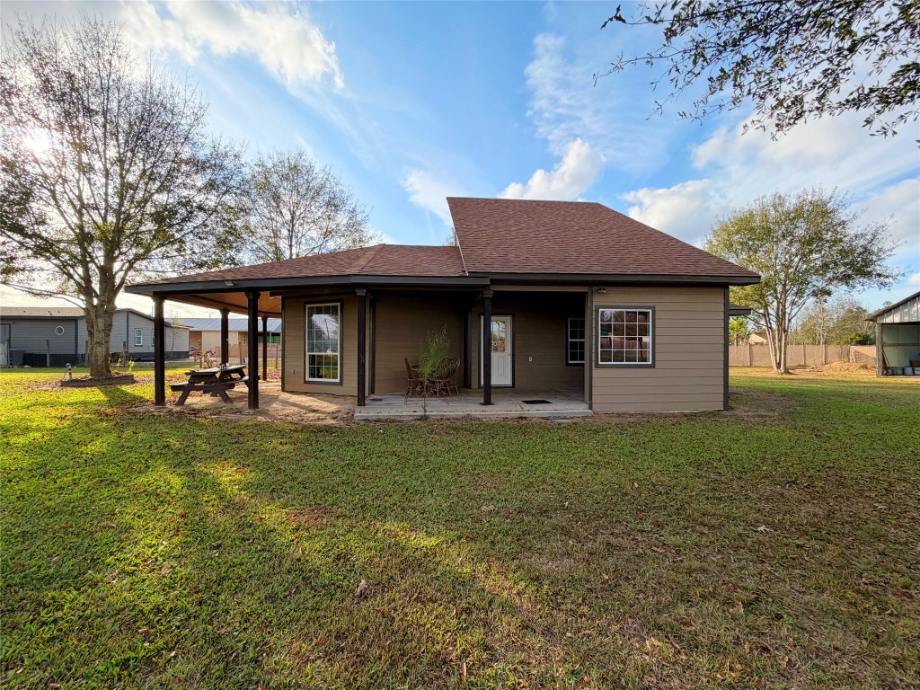369 Road 3556 Cleveland, TX 77327 - Photo 5 of 16 a front view of a house with a garden