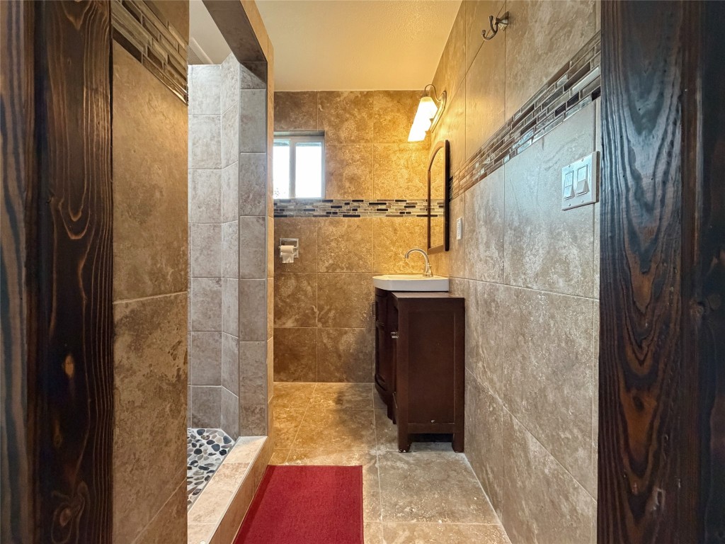 369 Road 3556 Cleveland, TX 77327 - Photo 10 of 16 a bathroom with a shower and a sink