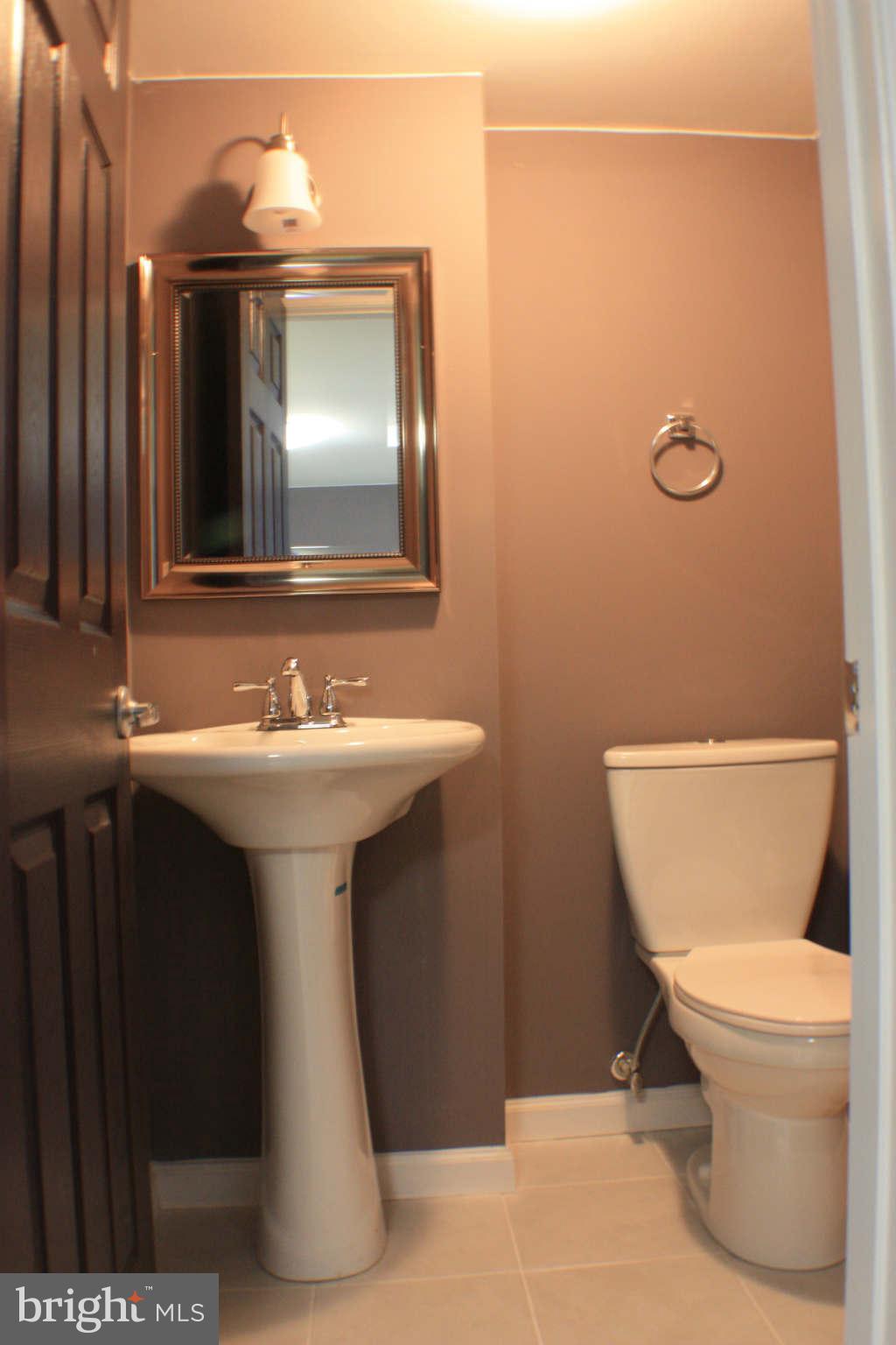 1540 Gleneagle Road Baltimore, MD 21239 - Photo 13 of 14 a bathroom with a sink toilet and mirror
