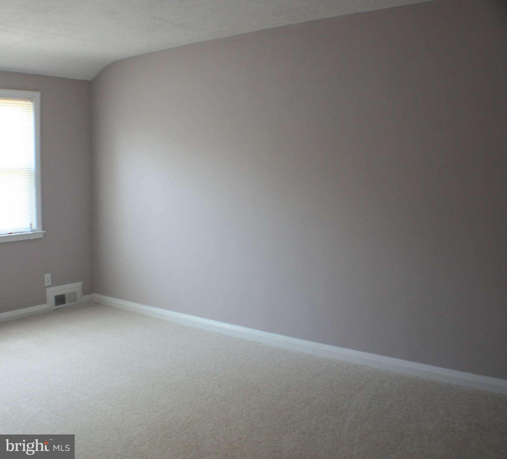 1540 Gleneagle Road Baltimore, MD 21239 - Photo 7 of 14 an empty room with a window