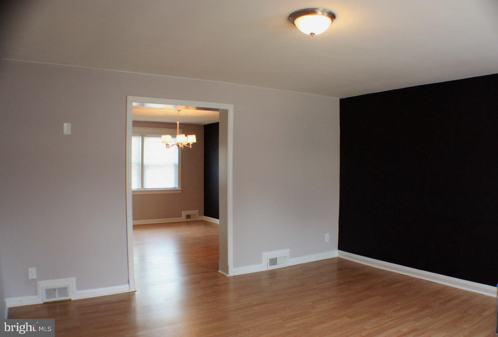 1540 Gleneagle Road Baltimore, MD 21239 - Photo 9 of 14 a view of an empty room with wooden floor and a window