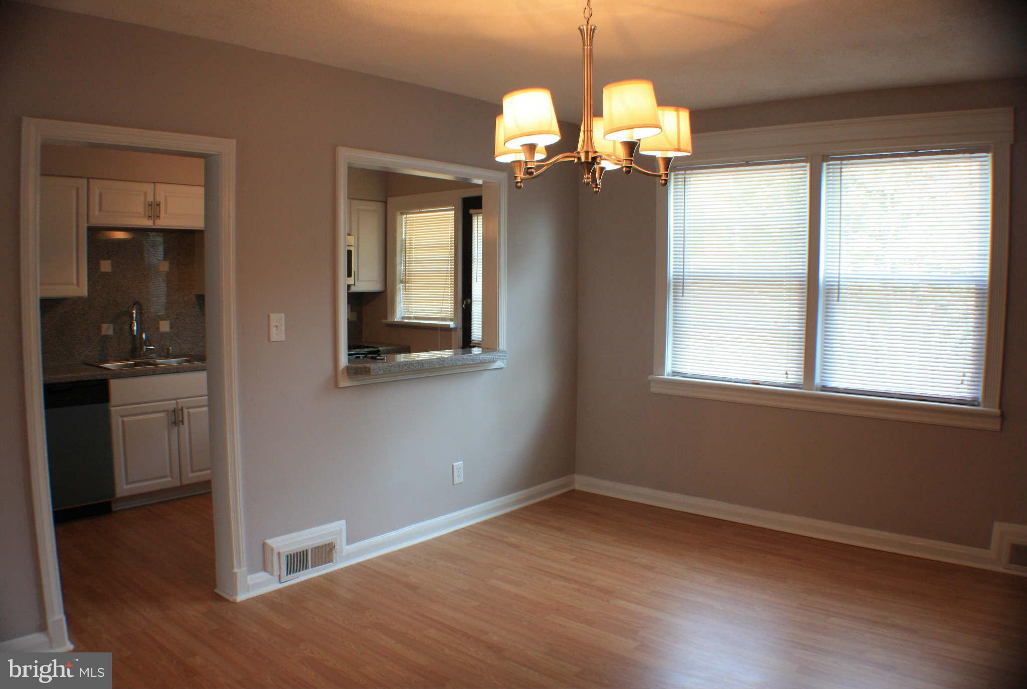 1540 Gleneagle Road Baltimore, MD 21239 - Photo 10 of 14 a view of a livingroom with a chandelier hardwood floor and staircase