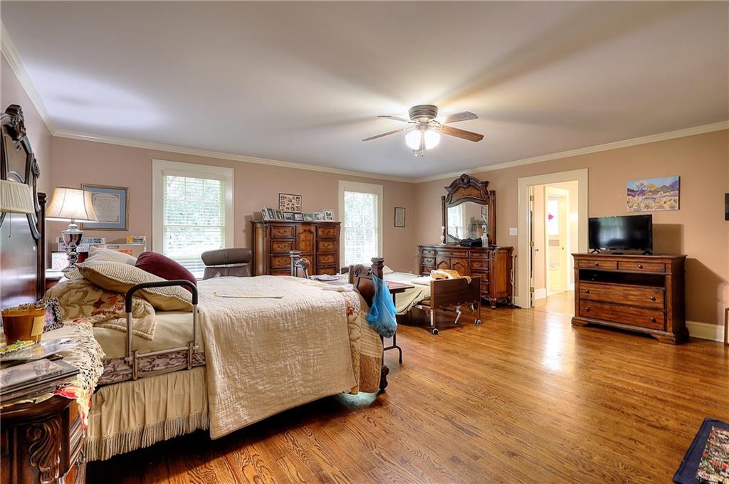 317 North Cherokee Road Social Circle, GA 30025 - Photo 16 of 32 a bed room with furniture and a chandelier