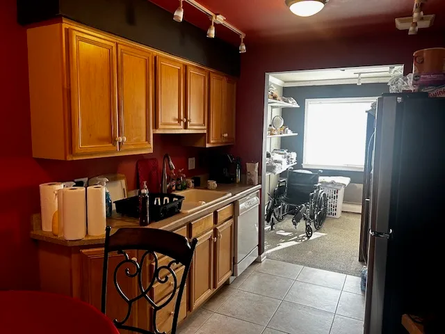 a kitchen with a refrigerator and a stove