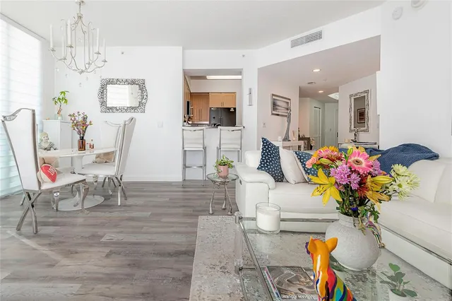 a bedroom with a large bed and a flat tv screen on dresser