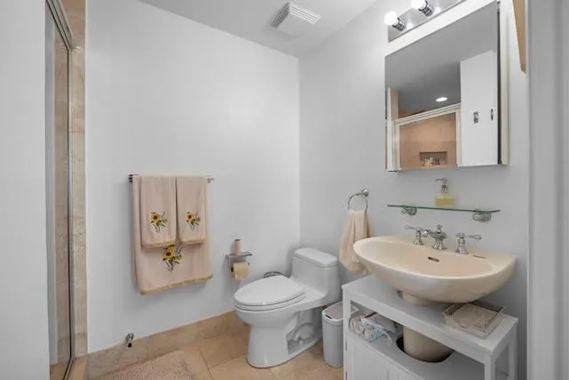 a kitchen with stainless steel appliances granite countertop a sink a stove a microwave and cabinets