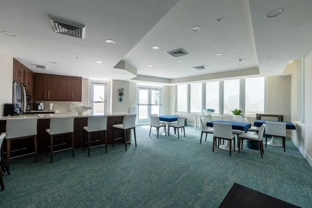 a spacious en suite bathroom with a granite countertop sink a large mirror and a bathtub