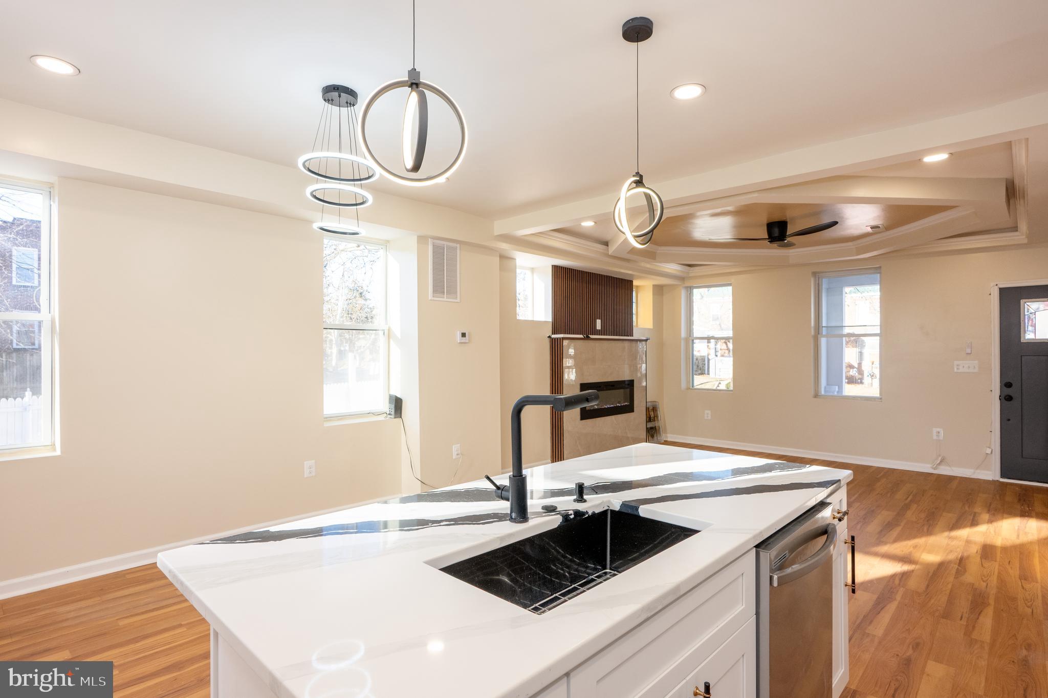3121 Sequoia Avenue Baltimore, MD 21215 - Photo 11 of 30 a kitchen with a sink dishwasher a stove and white cabinets with wooden floor
