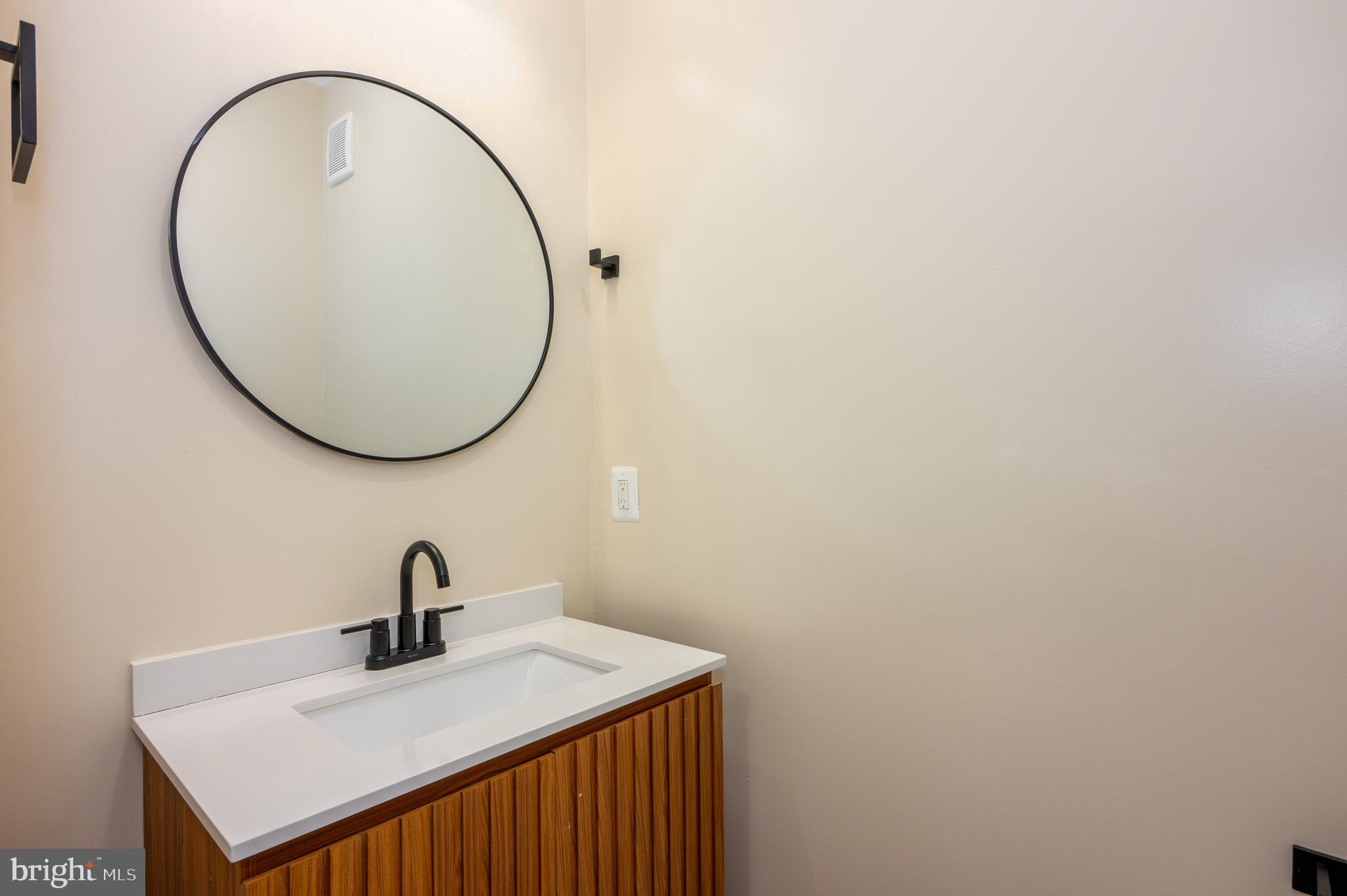 3121 Sequoia Avenue Baltimore, MD 21215 - Photo 13 of 30 a bathroom with a sink and a mirror