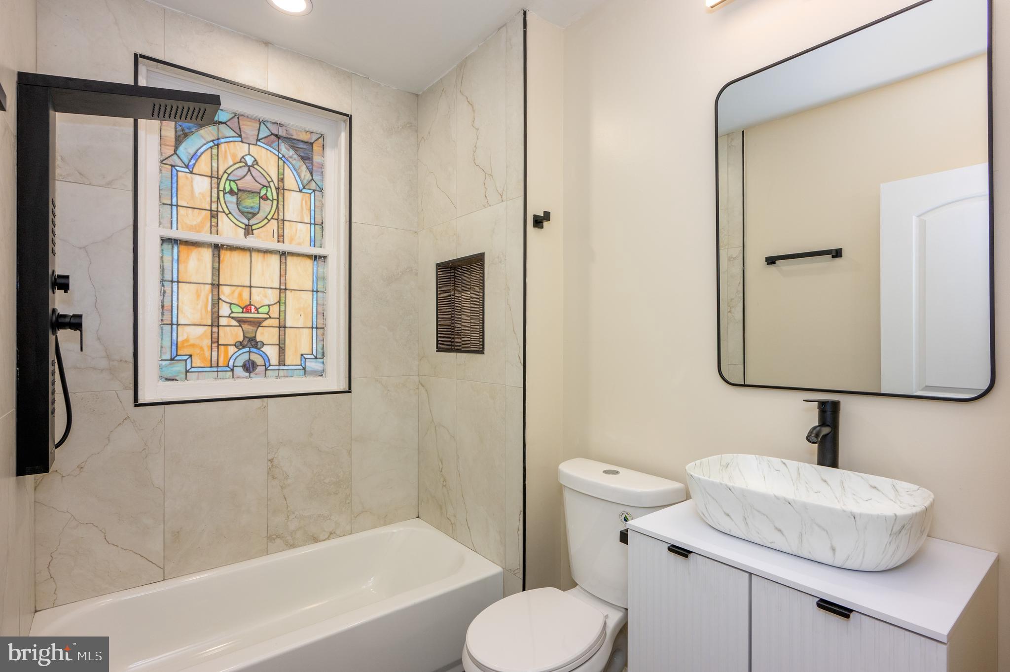 3121 Sequoia Avenue Baltimore, MD 21215 - Photo 19 of 30 a bathroom with a toilet sink and mirror