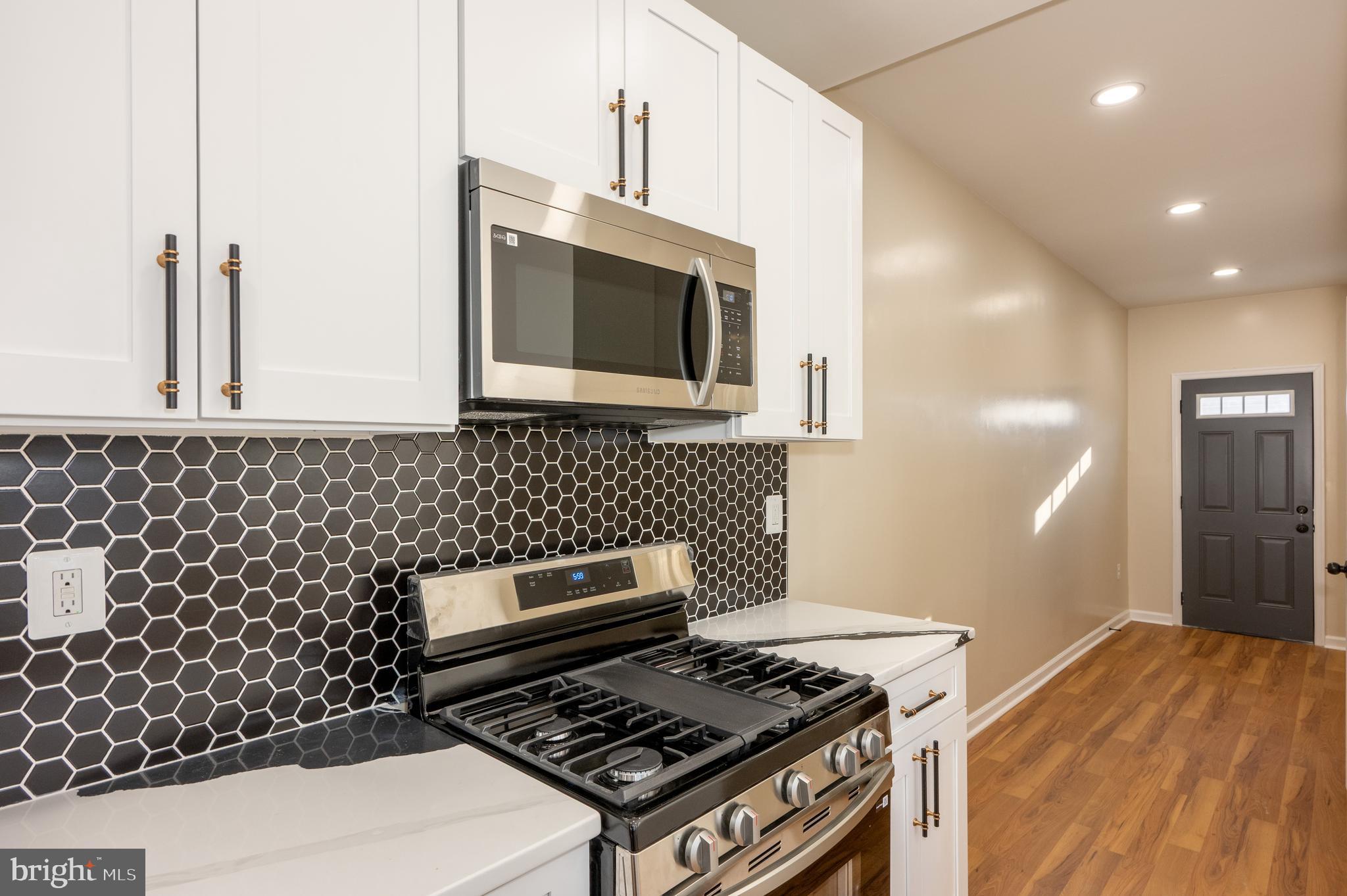 3121 Sequoia Avenue Baltimore, MD 21215 - Photo 10 of 30 a kitchen with a stove and a microwave