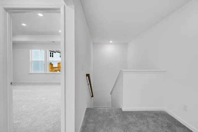 a view of a hallway with wooden floor and entryway