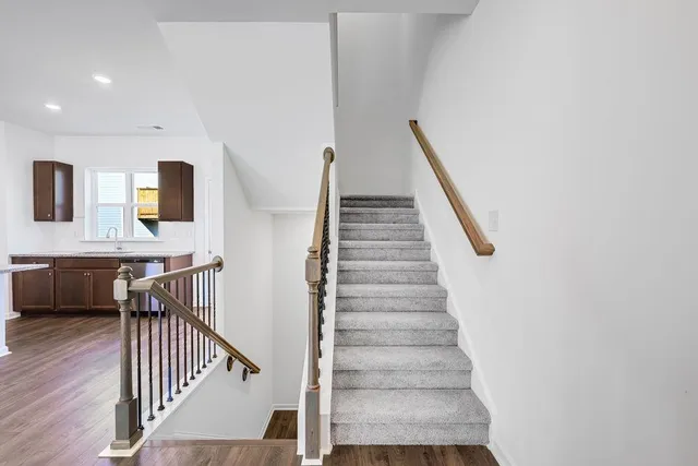 a view of entryway and hall with wooden floor