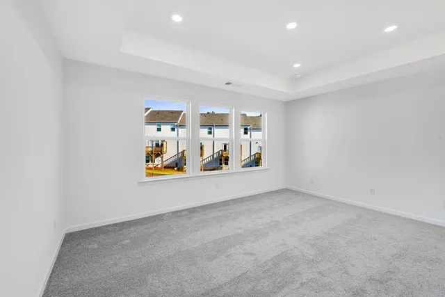 an empty room with painting and refrigerator