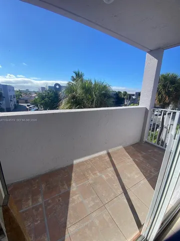 a view of roof deck with furniture and city view