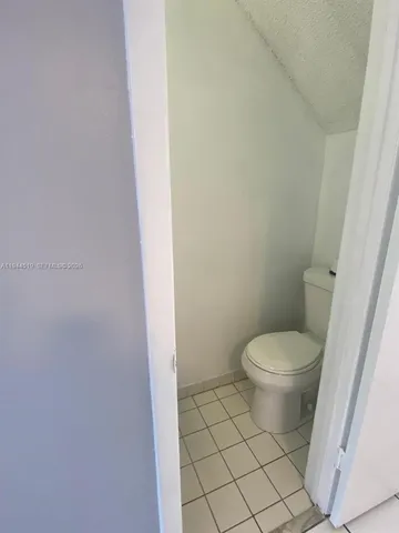 a white toilet sitting next to a white cabinet