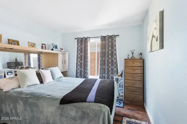 a bedroom with a bed and a dresser in it