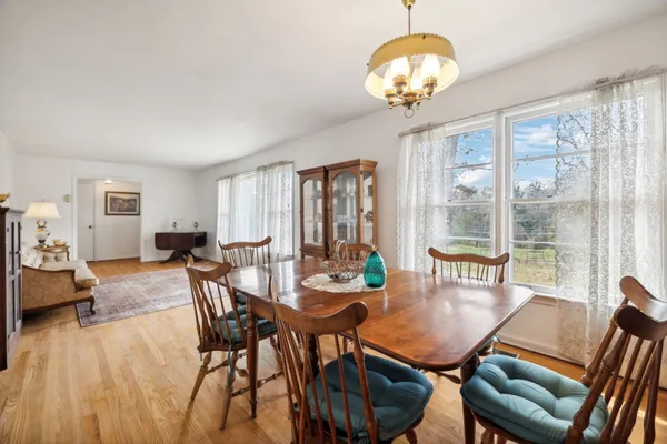 a large living room with stainless steel appliances granite countertop furniture and a large window