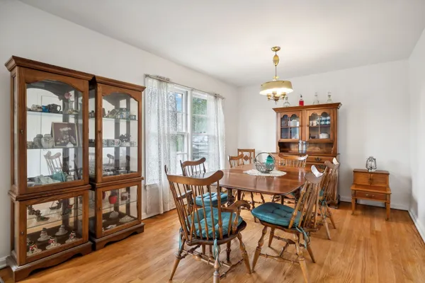 a view of a dining room with furniture wooden floor and chandelier