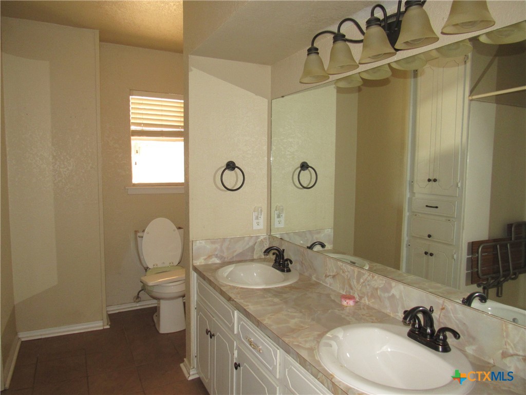 1325 Paseo Del Cobre Temple, TX 76502 - Photo 10 of 15 a bathroom with a granite countertop sink toilet and shower