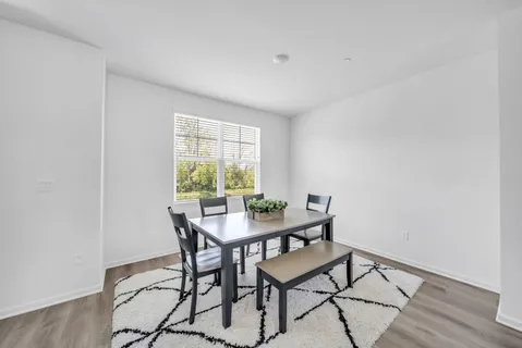 a living room with furniture and large windows