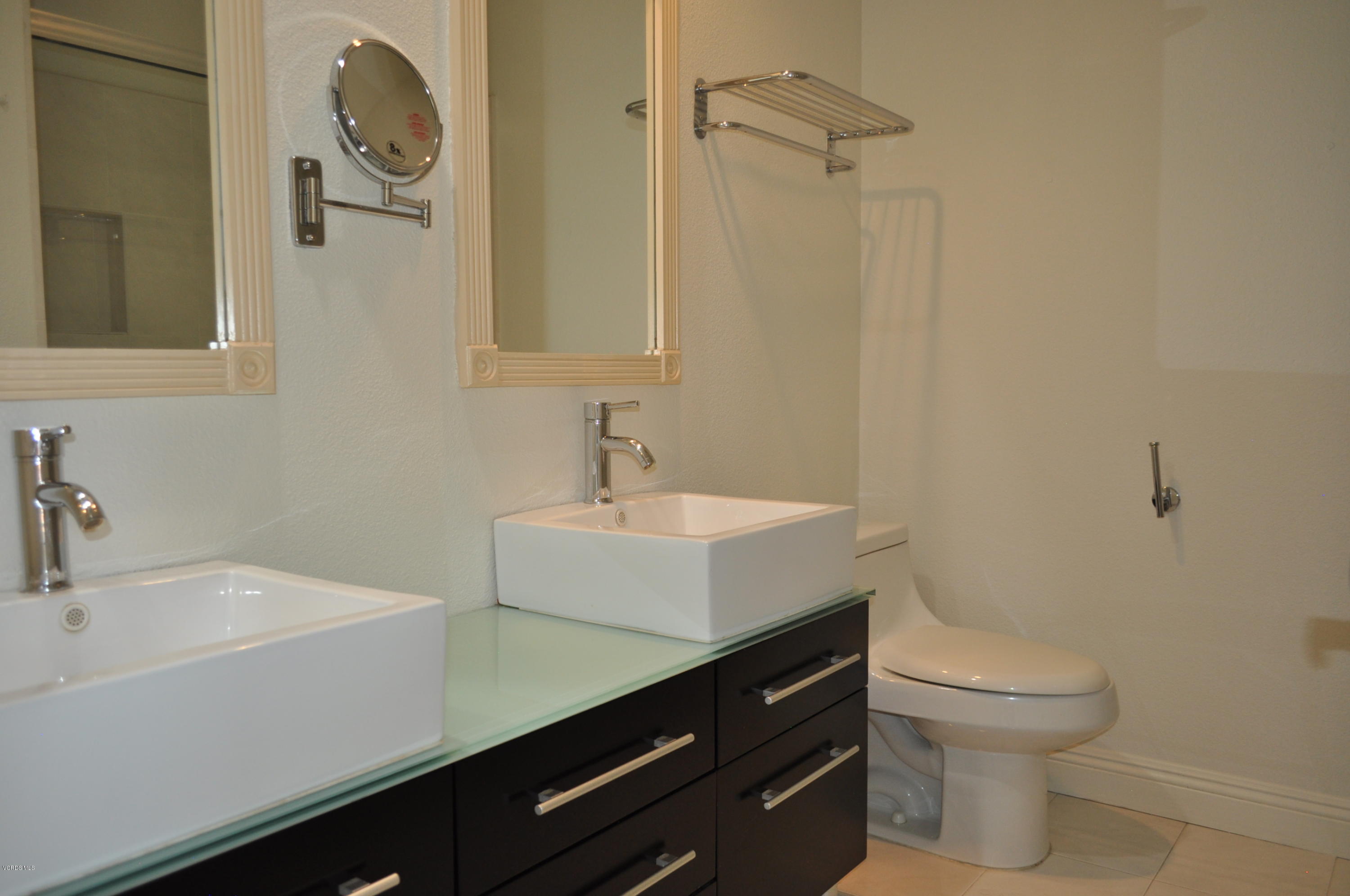 4852 Penrose Avenue Moorpark, CA 93021 - Photo 13 of 20 a bathroom with a sink a toilet and a mirror