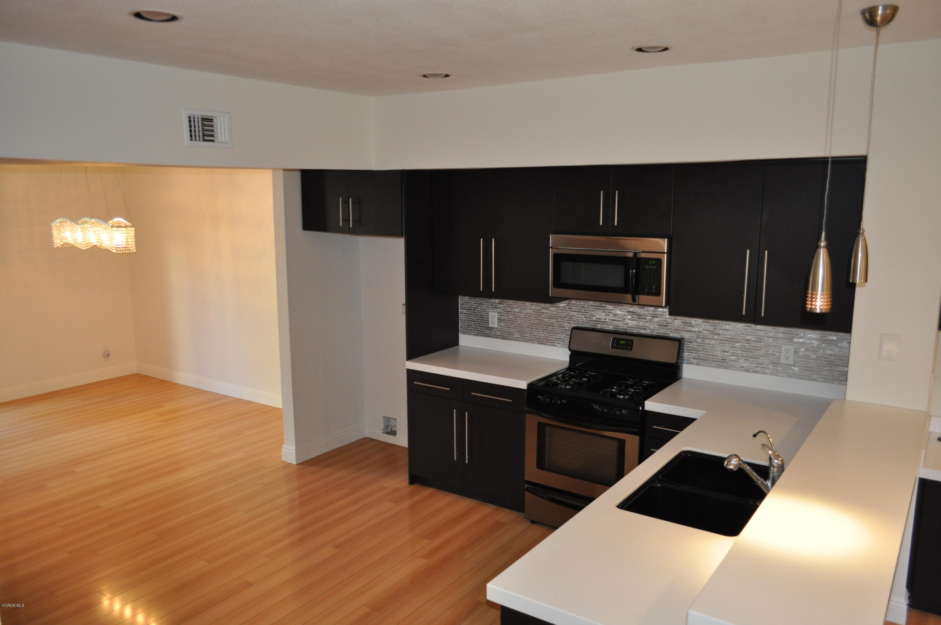 4852 Penrose Avenue Moorpark, CA 93021 - Photo 3 of 20 a kitchen with a sink a stove and refrigerator